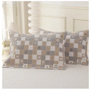 Detailed view of soft cotton checkered pillowcases with cute bear and flower prints for home.