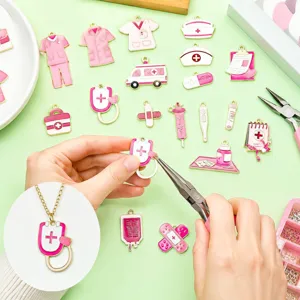Close-up showing pink enamel medical themed charms being assembled into a handmade necklace