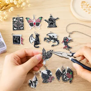 Close-up of assembling gothic dark enamel Halloween charms with pliers for DIY jewelry