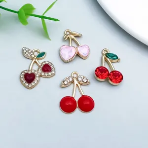 Detailansicht von roten und rosa kristalbesetzten Kirschanhängern für Schmuck-DIY.