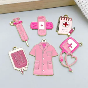 Detailed view of pink enamel medical charms including syringe, bandage, and nurse uniform