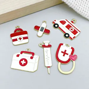 Detail view of red and white enamel medical charms for DIY jewelry making and crafts