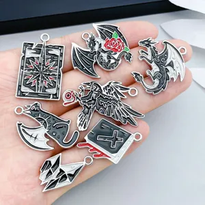 Macro view of dark enamel alloy gothic pendants featuring dragons, ravens, and bats for DIY jewelry