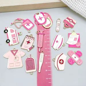 Close-up of pink medical enamel alloy charms including stethoscope and bandage designs