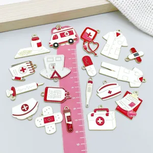 Close-up of variety red and white medical-themed enamel charms with scale ruler for DIY crafts