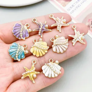 Close-up of colorful enamel starfish and shell charms with pearls for DIY jewelry making
