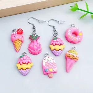 Detailed view of colorful resin ice cream and fruit charms for DIY jewelry making.
