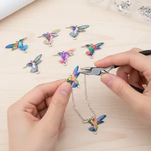 Macro view of assembling colorful hummingbird pendants into a necklace DIY project