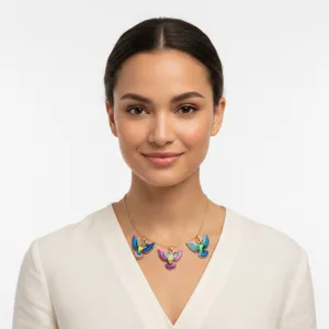 Detailed view of a woman wearing a colorful oil-drop hummingbird pendant necklace.