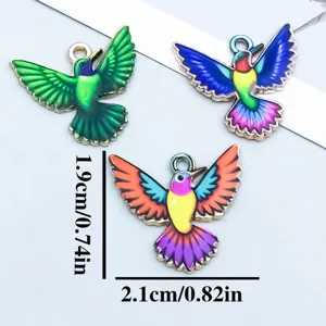Detailed size view of colorful enamel hummingbird charms for DIY jewelry making