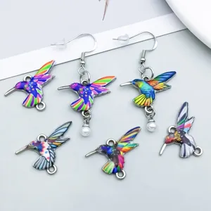 Detailed close-up of colorful enamel hummingbird pendants and DIY earring jewelry accessories