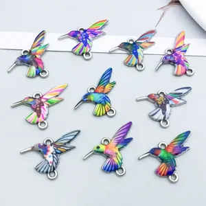 Macro detail view of colorful enamel printed hummingbird charms for DIY jewelry making