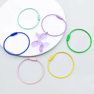 Detailed view of colorful alloy wire keyrings and a purple balloon dog pendant