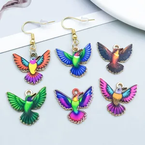 Detail view of colorful oil-dripping alloy hummingbird charms for DIY jewelry making