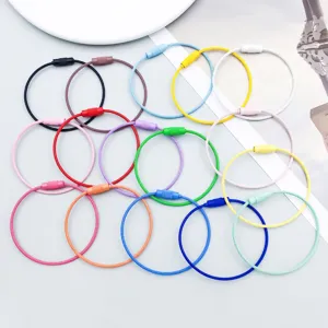 Close-up of colorful painted steel wire rings with screw connectors for DIY crafts