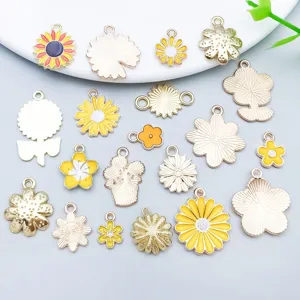 Detailed view of 20 mixed yellow enamel daisy and sunflower alloy charms for DIY jewelry