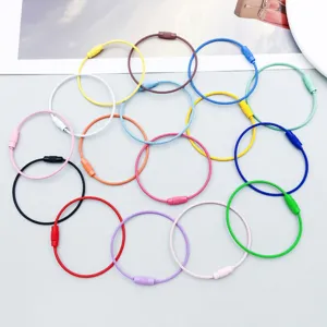 Detailed view of multiple colorful twist-lock steel wire rings for keychains and crafts
