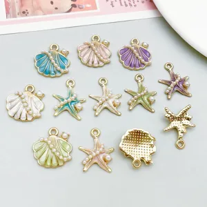 Detailed view of colorful enamel starfish and shell jewelry charms with imitation pearls.