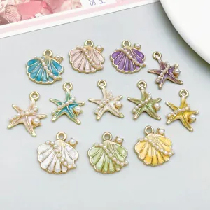 Detailed view of colorful enamel sea star and shell charms with faux pearls for DIY crafts