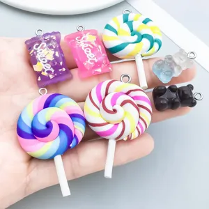 Close-up view of colorful resin lollipop and gummy bear charms for DIY jewelry making