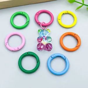 Detail of colorful painted spring ring clasps and gummy bear charm for DIY jewelry