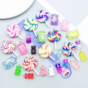 Detailed view of colorful gradient resin lollipop and gummy bear pendants for DIY crafts.
