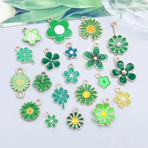 Detailansicht von zwanzig gemischten grünen Emaille-Blumen- und Kleeblatt-Anhängern für DIY
