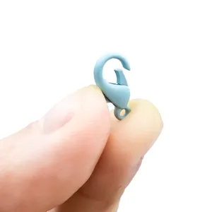 Close-up of a small light blue painted lobster clasp held by fingers for size reference