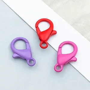 Detail view of three colorful matte lacquer alloy lobster clasps for DIY jewelry
