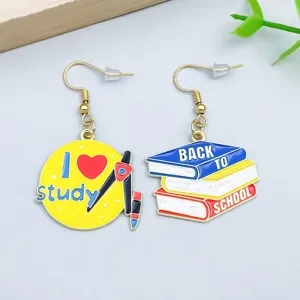 Close-up of school-themed enamel earrings with back to school and study design