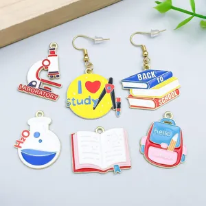 Variety of colorful enamel school-themed charms including books, microscope, and backpack.