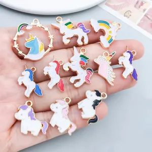 Detailed view of colorful enamel unicorn and rainbow pendants for DIY jewelry making