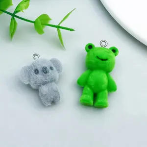 Close-up of cute flocked koala and green bear charms for DIY jewelry making