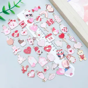 Detailed view of mixed Valentine's Day alloy charms with ruler for size reference