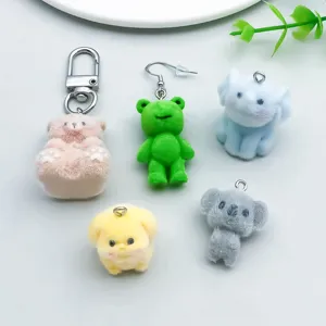 Close-up of colorful flocked resin animal charms showing soft texture for DIY jewelry.