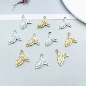 Detailed view showing gold and silver mermaid tail pendants with small pearl accents