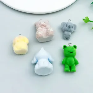 Detailed view of colorful flocked resin animal charms including bear, frog and koala