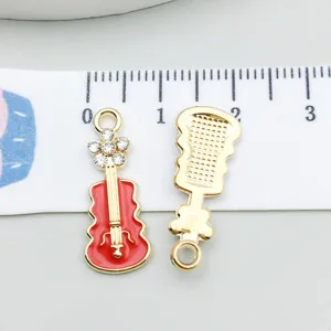 Detailed view of red enamel guitar pendant with scale for size comparison