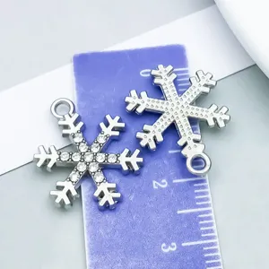 Detail view showing snowflake pendant size with rhinestones and textured metal back