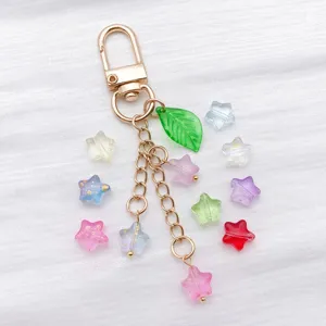 Close-up of colorful transparent glass star beads with gold sprinkles for DIY crafts