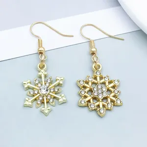Close-up detail of golden snowflake earrings with sparkling rhinestones for Christmas.