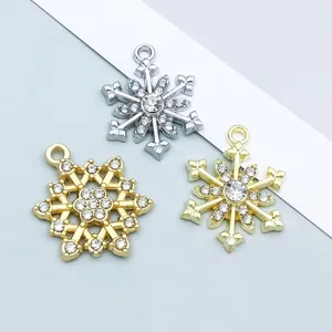 Detailed view of gold and silver snowflake pendants with sparkling rhinestones for DIY crafts
