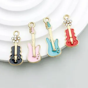 Macro view of colorful enamel musical instrument charms with rhinestones for DIY jewelry