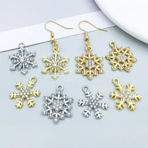 Detail view of gold and silver snowflake charms with rhinestones for DIY jewelry
