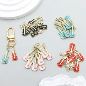 Close-up of colorful enamel guitar charms with crystal flowers for jewelry DIY