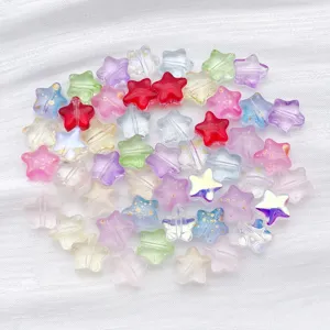 Close-up of colorful transparent gold-flecked glass star beads for DIY jewelry making