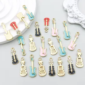 Detailed view of colorful enamel guitar and violin charms with rhinestone accents