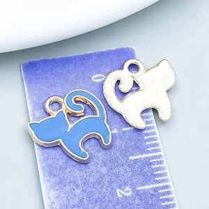 Macro detail of blue enamel cat charms showing front and back for DIY jewelry making