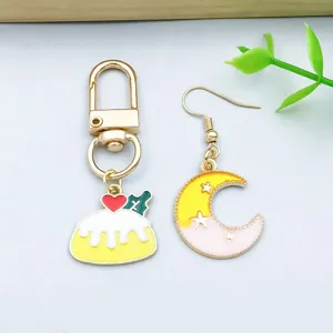 Detailed macro view of yellow enamel alloy moon and heart dessert charms for DIY crafts