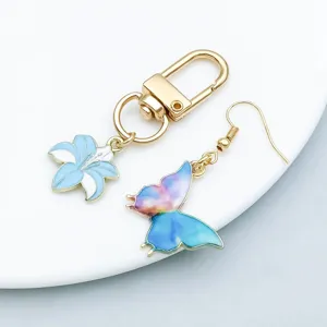 Close-up of lake blue oil-drop lily pendant keychain and colorful butterfly earring accessories
